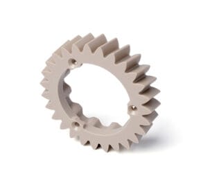 Precision CNC machined PEEK (polyetheretherketone) high-performance plastic spur gear with precision teeth, central bore, and three mounting holes
