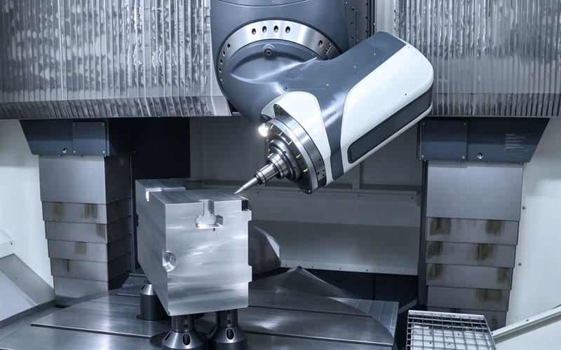 3+2 fixed axis machining center with swivel milling head at inclined angle machining rectangular metal workpiece with T-slot, positional 5-axis CNC machining in clean industrial environment