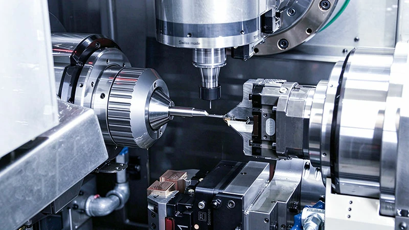 CNC Swiss turning machine performing live tool milling on a slender medical-grade shaft
