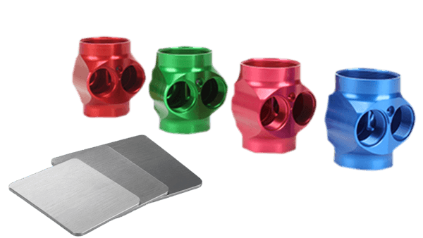Custom precision color anodized aluminum (6061-T6) CNC machined valve bodies - multi-port fittings with threaded holes in red, green, blue, and pink for automotive and pneumatic applications
