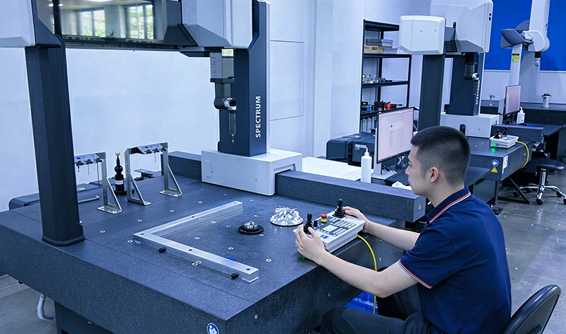 CMM Coordinate Measuring Machine Precision Quality Inspection - Technician Operating Zeiss Spectrum CMM for Dimensional Inspection of CNC Machined Precision Component