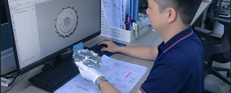 Quality Control Engineer Reviewing CMM Inspection Report and Dimensional Measurement Results for Precision Machined Impeller Component