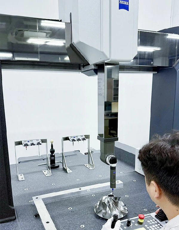 Zeiss coordinate measuring machine inspecting a 5-axis machined titanium impeller in a precision metrology lab